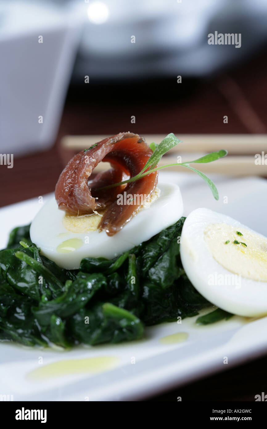 Spinachs with anchovies and hard boiled eggs Stock Photo Alamy