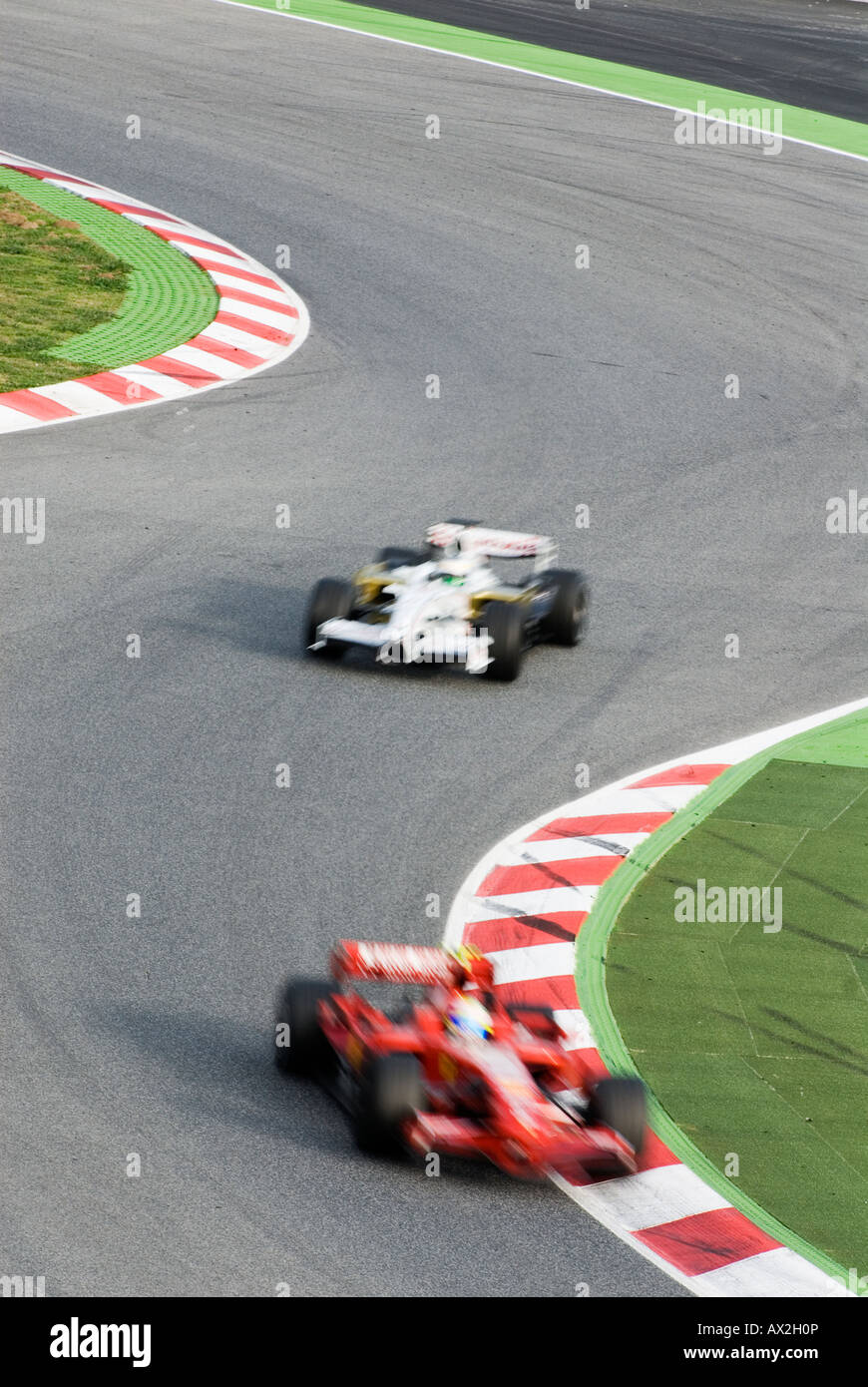 Two Formula 1 Race Cars Speeds Through Double Bend Curve In Racetrack Stock Photo Alamy