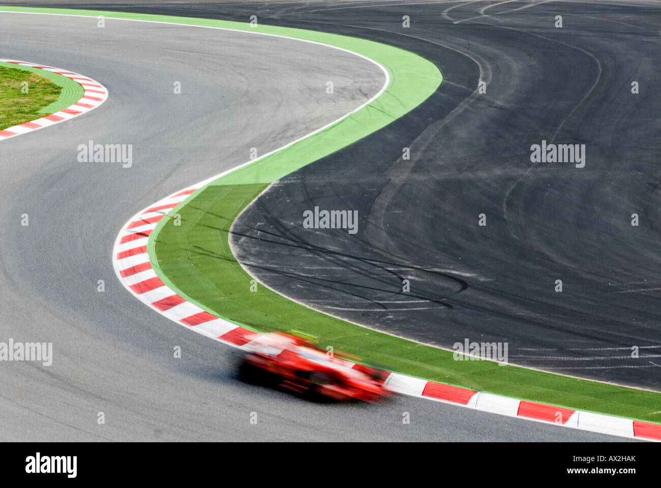 Formula 1 Racecar speeds through double bend curve in racetrack Stock ...