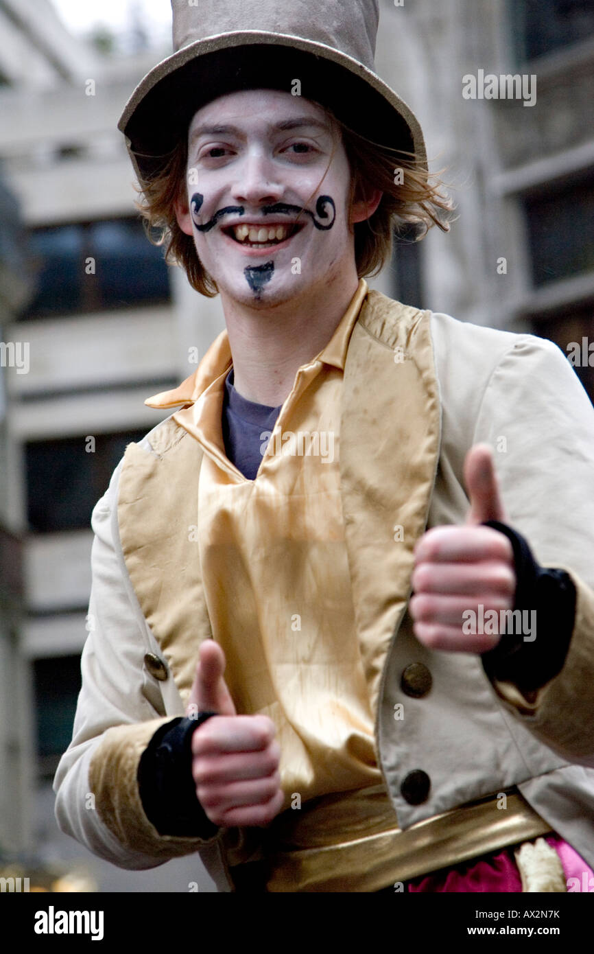 A face painted man on stilts waving to to the crowd at the Saint Patrick s Day celebration London 2008 giving two thumbs up Stock Photo
