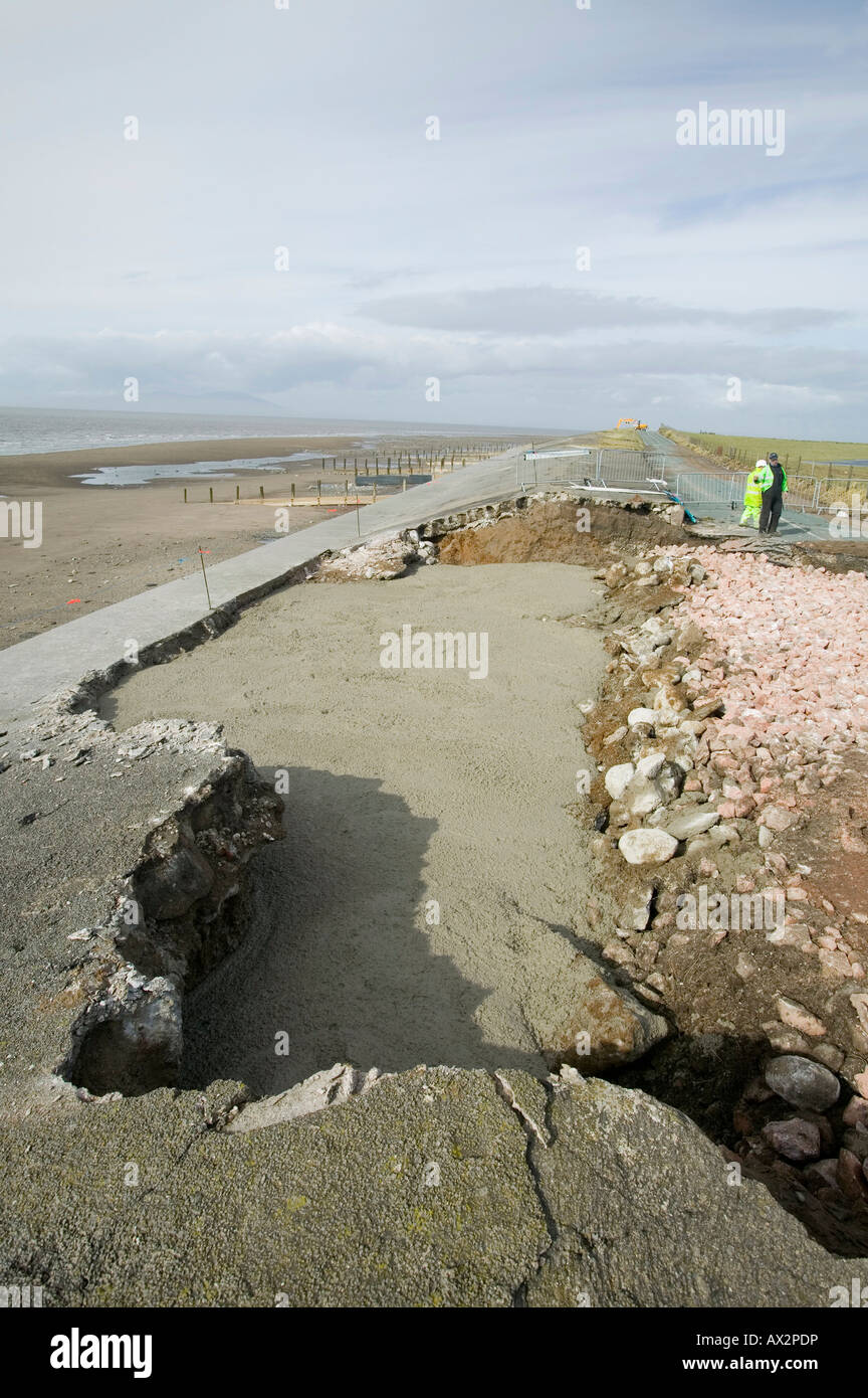 repairing a hole in the road near Allonby, Cumbria caused by extreme storm which undermined the sea wall causing it to collapse Stock Photo