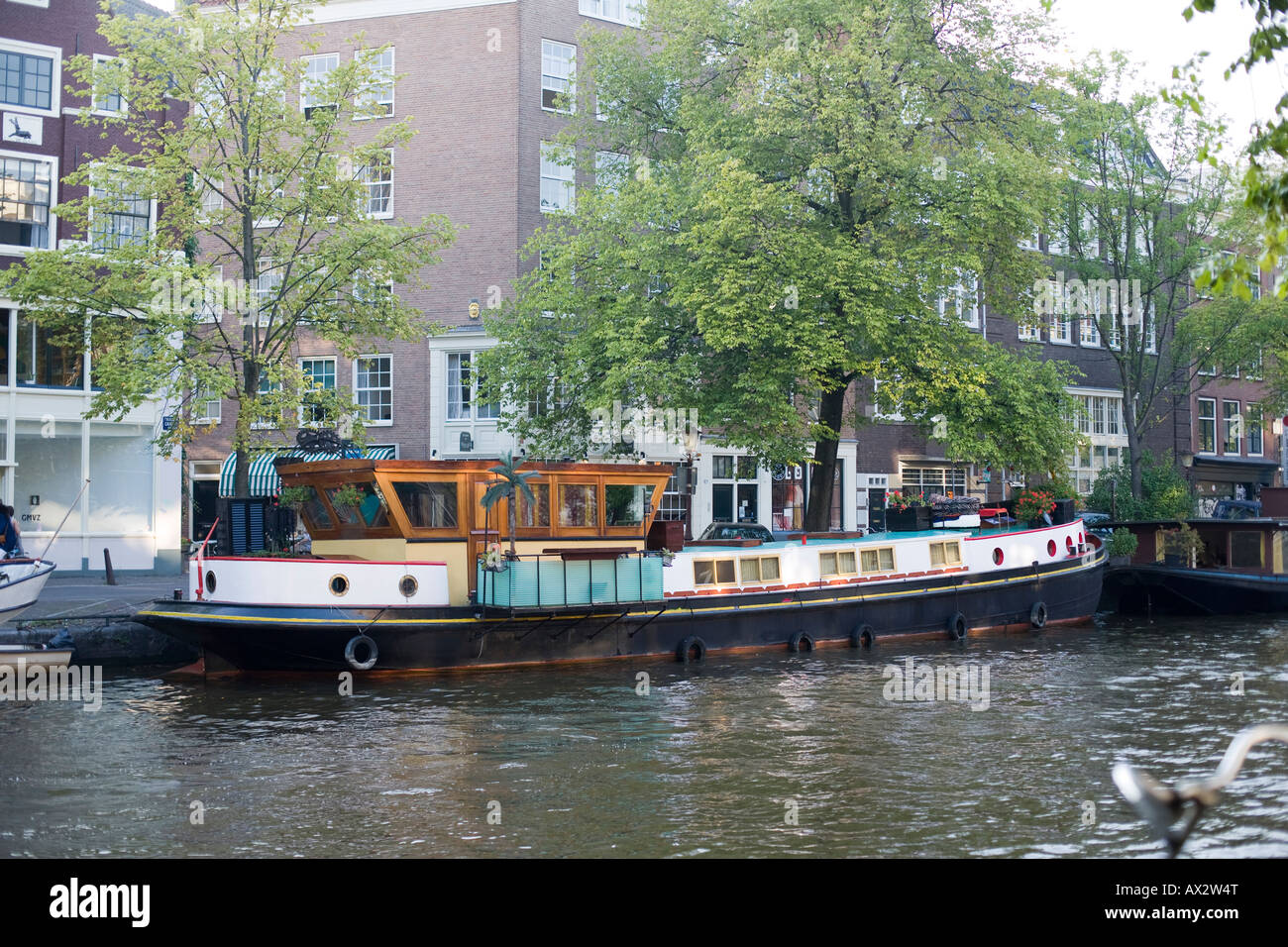 boat moored on a river bank with buildings in the background Stock ...