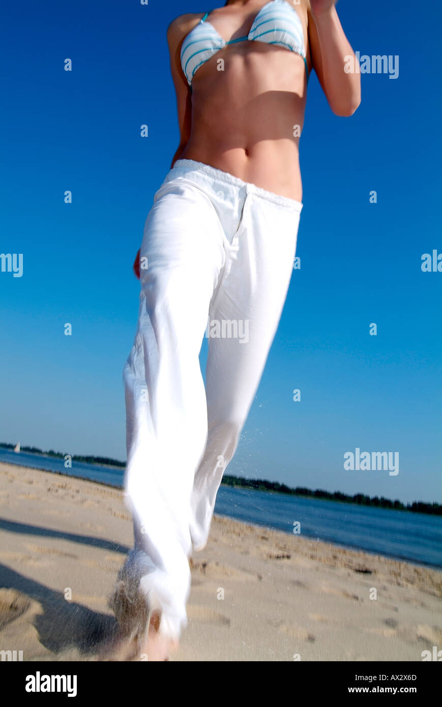 woman beach motion sport holiday fun summer sun sky blue emotions dynamic Stock Photo