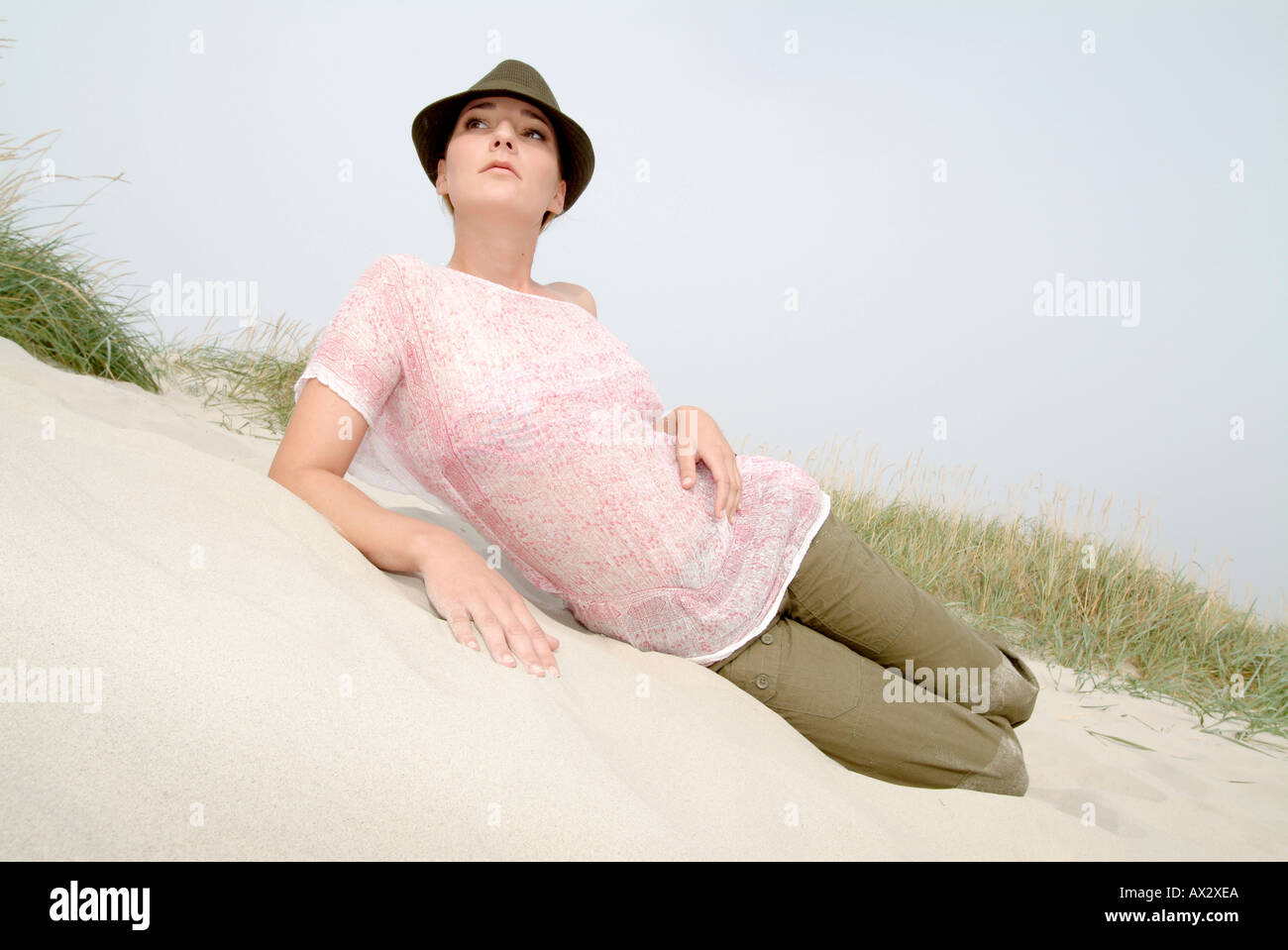 young girl coast grass sands beach sky hot Sommer Sonne Strand fashion Stock Photo