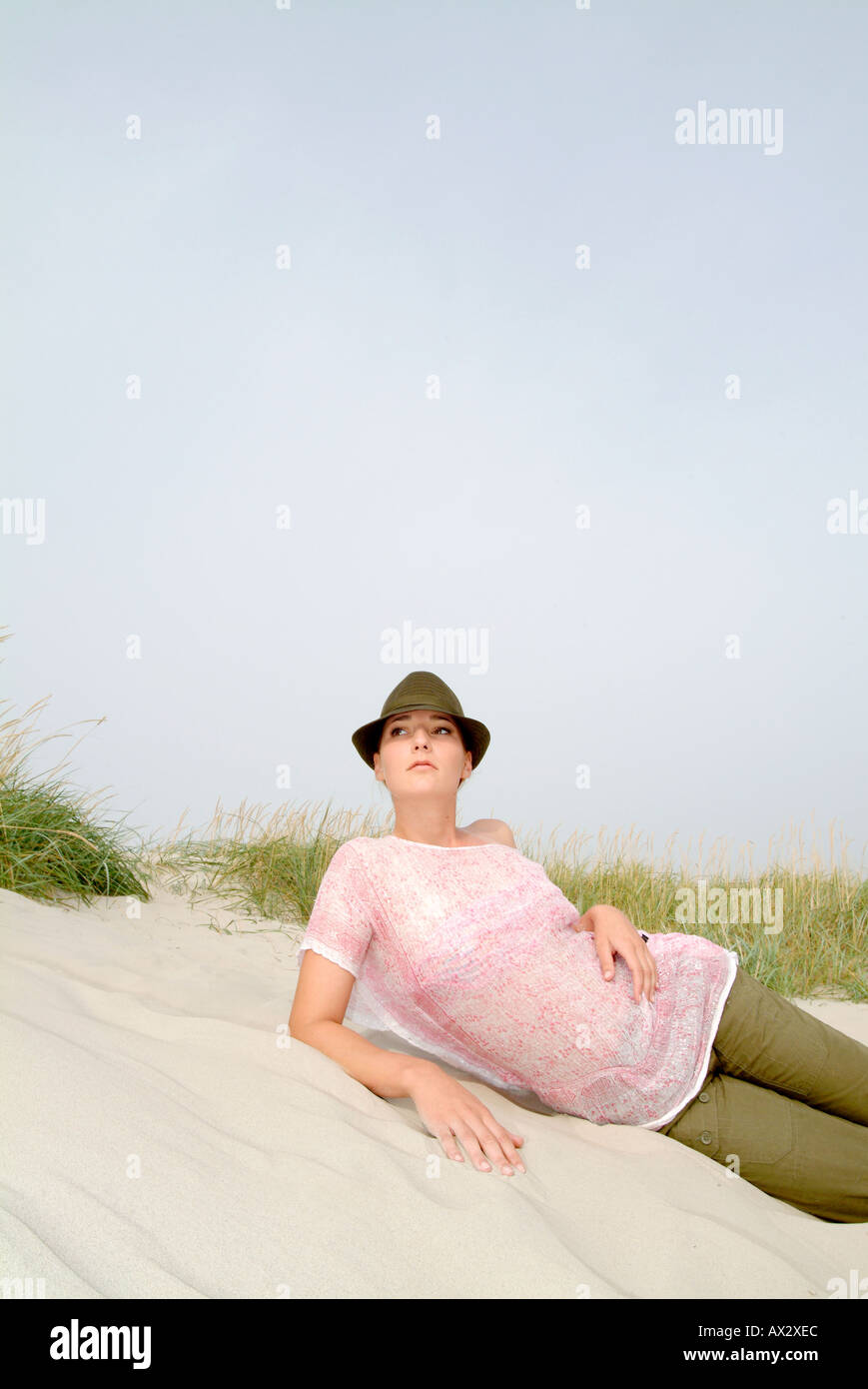 young girl coast grass sands beach sky hot summer sand  fashion Stock Photo