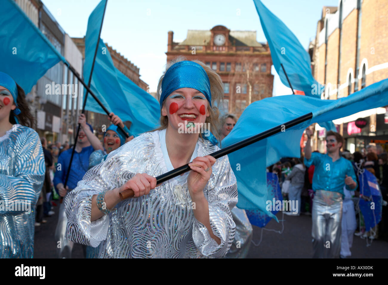 dancers with blue flags taking part in the parade and carnival on st patricks day belfast northern ireland Stock Photo