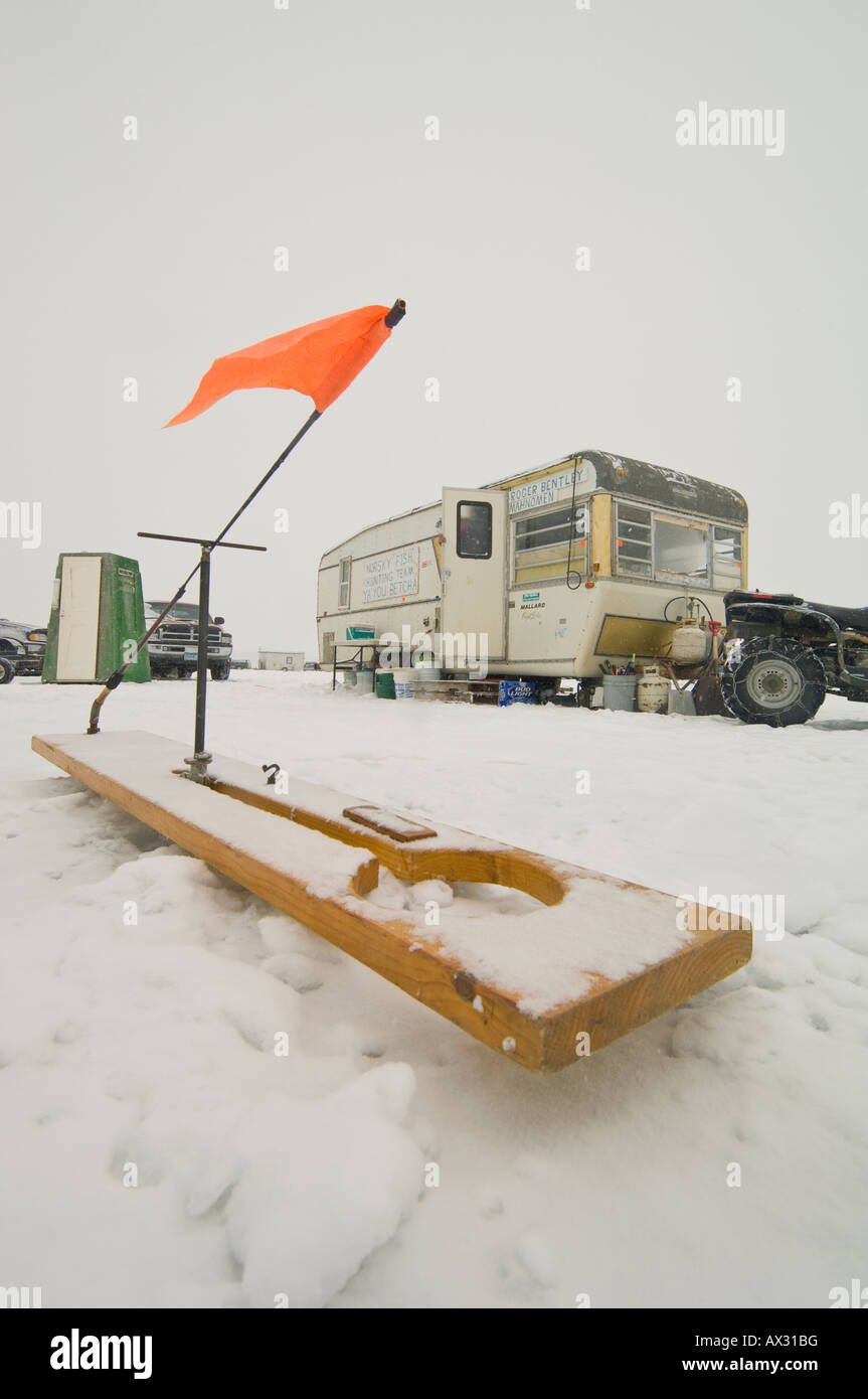 A LARGE TIP UP ICE FISHING LINE SITS OUT IN FRONT OF AN ICE HOUSE Stock  Photo - Alamy
