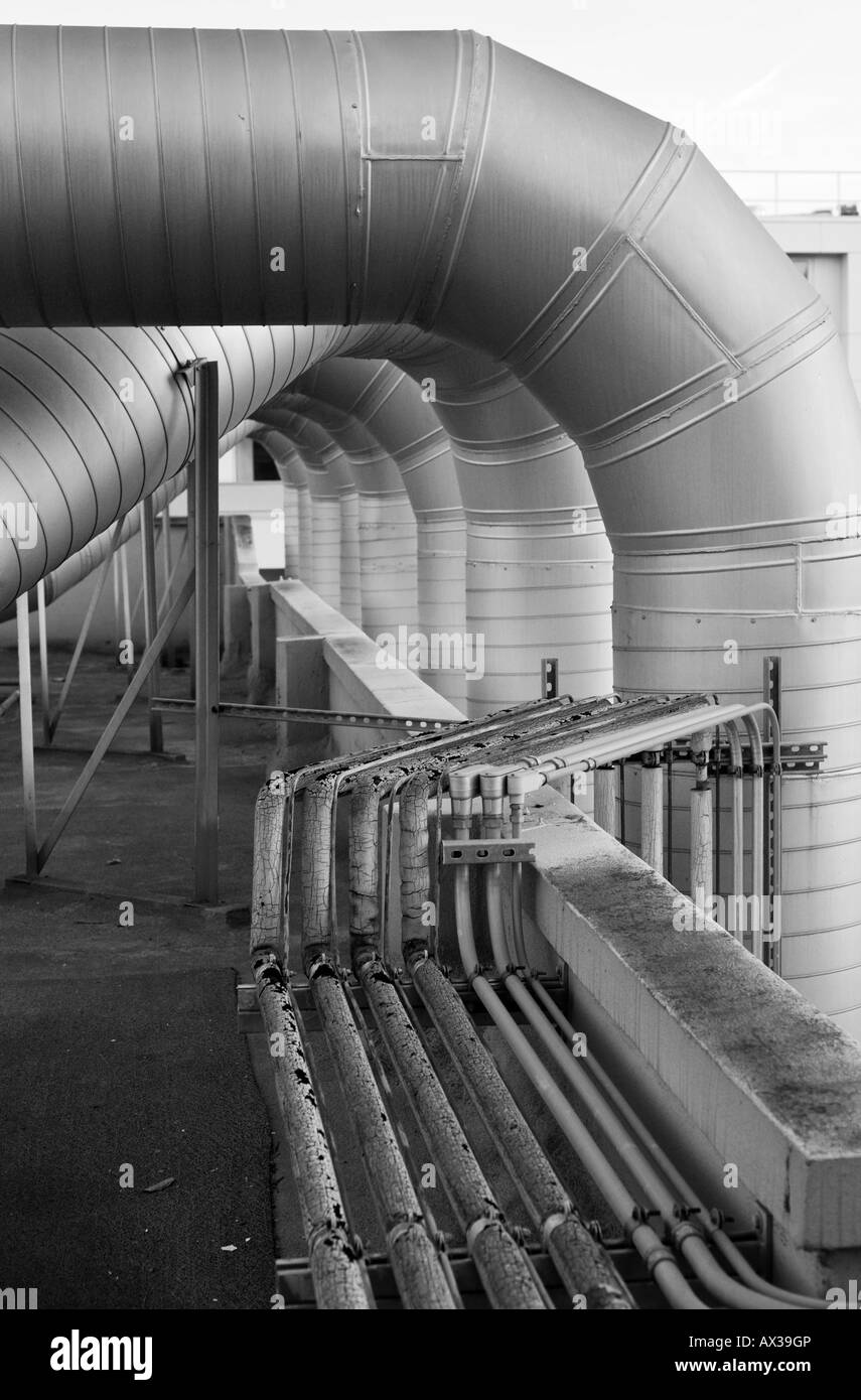 Ventilation ducts and other conduits on a rooftop. Stock Photo