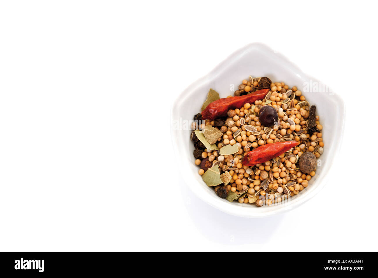 Mixed spices with chilis in bowl, elevated view Stock Photo