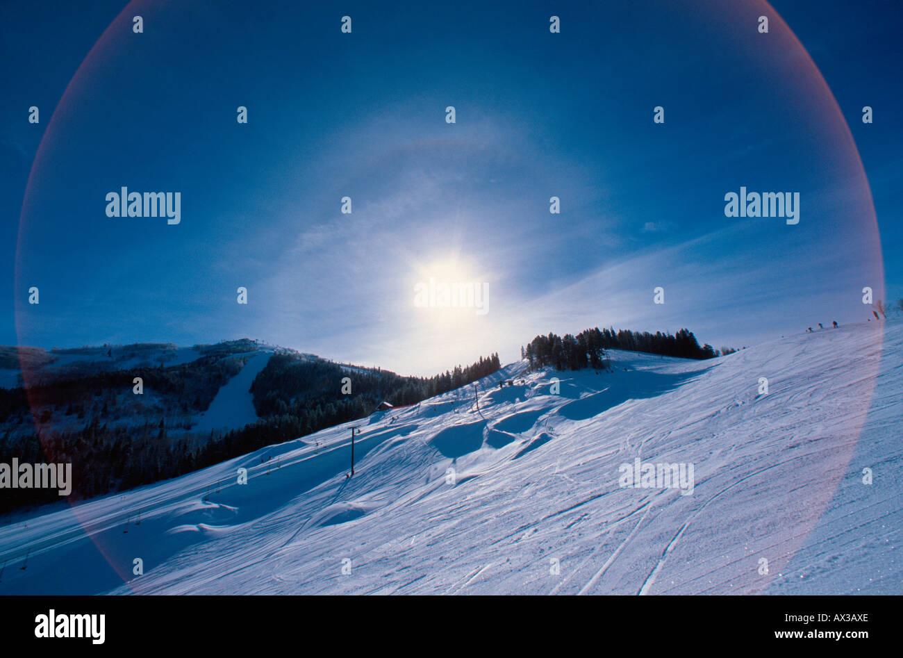 Sundog and lens flare in sky over Bashor Bowl ski run Steamboat Springs Colorado USA Stock Photo