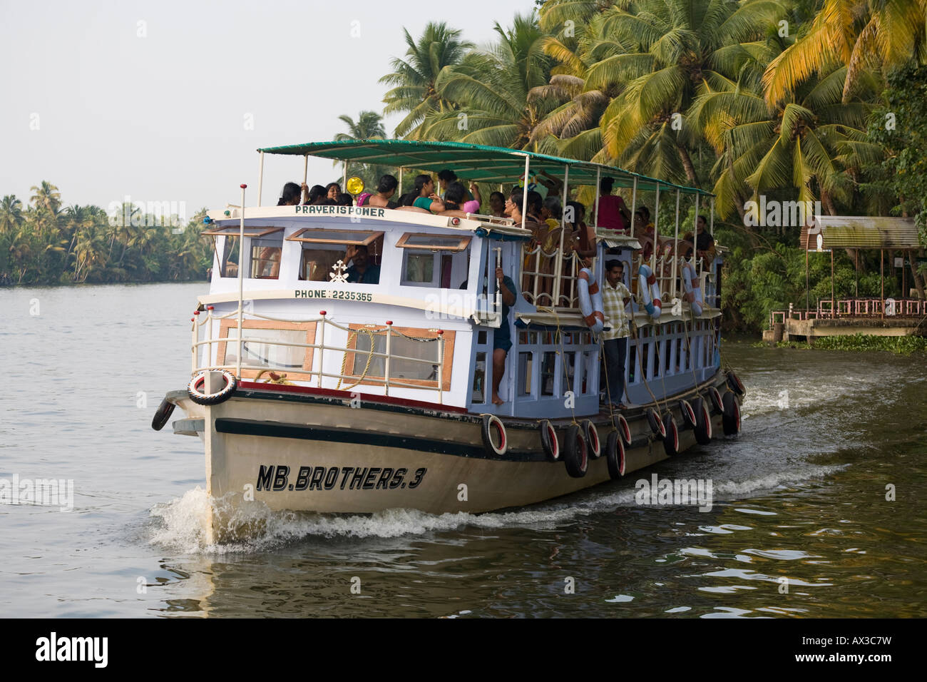 Commuters on a ferry boat on the river, near Kainakary, Alleppey District, Kerala, India Stock Photo