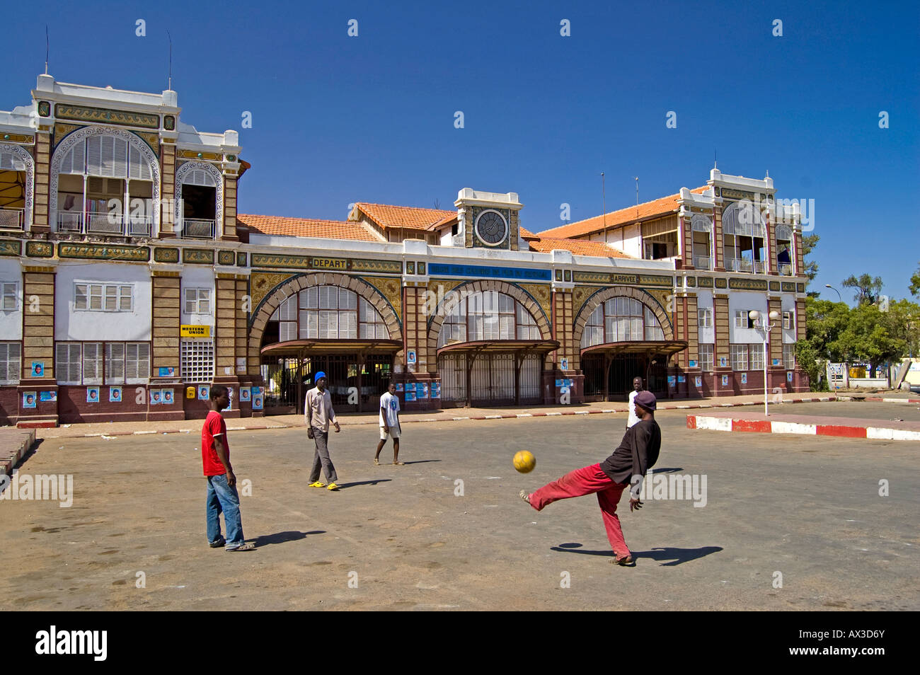 Travel, Senegal, Dakar, Local boys playing football in street outside central railway station, Stock Photo