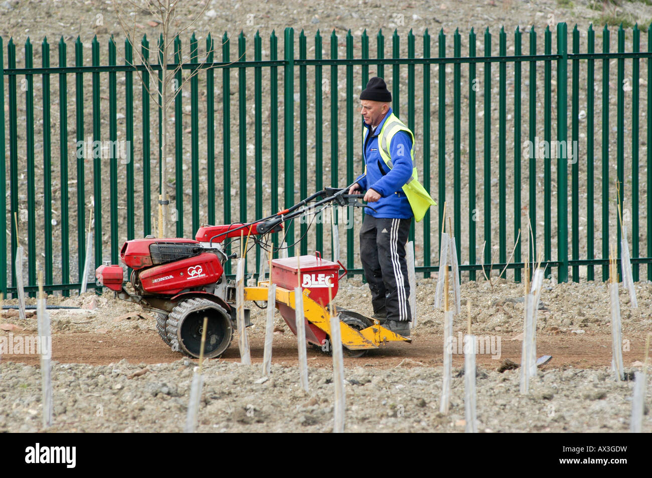 man operating a machine to level ground on a construction site in the