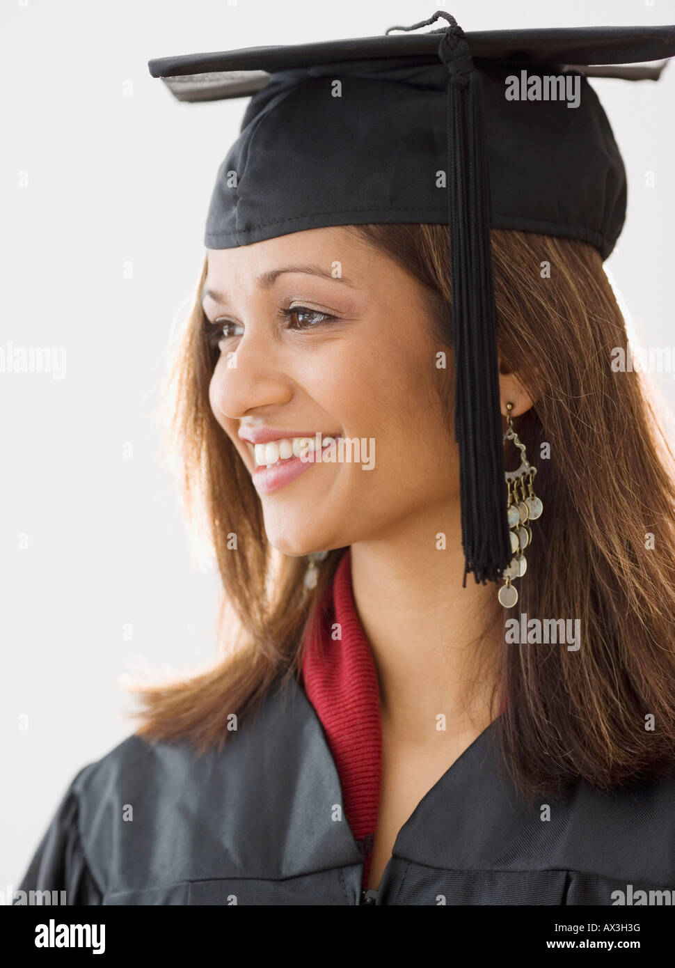 Indian woman wearing graduation cap and gown Stock Photo Alamy