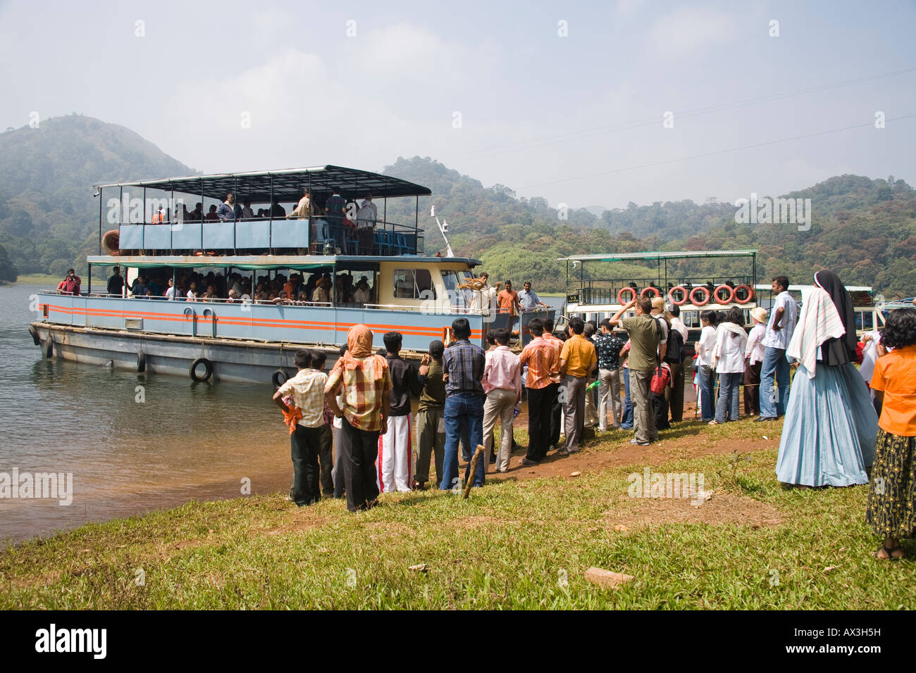Tourists on pleasure boat, Periyar Lake, Periyar Wildlife Sanctuary, Thekkady, near Kumily, Kerala, India Stock Photo