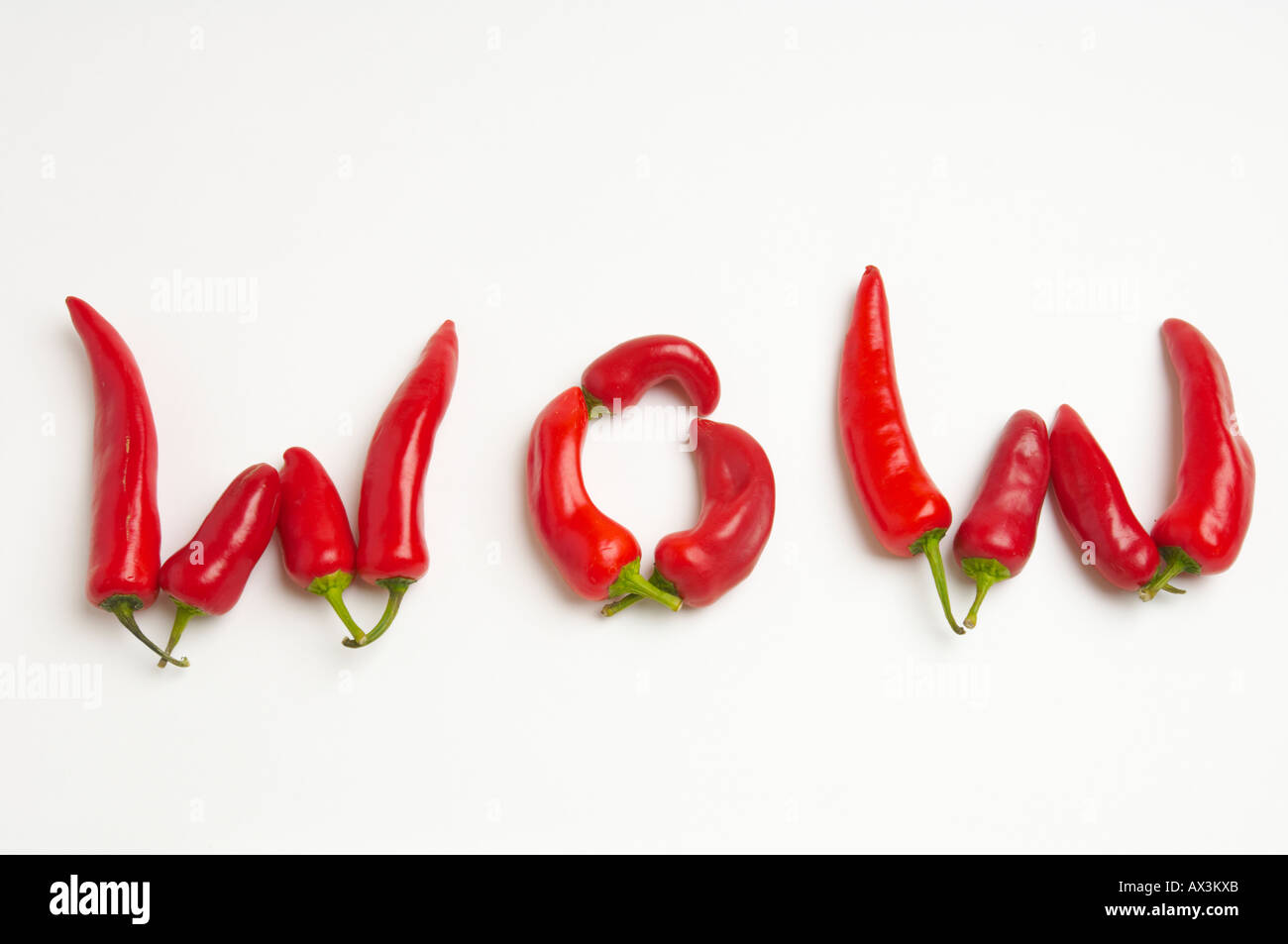 Red chili peppers spell out words relating to their taste Stock Photo