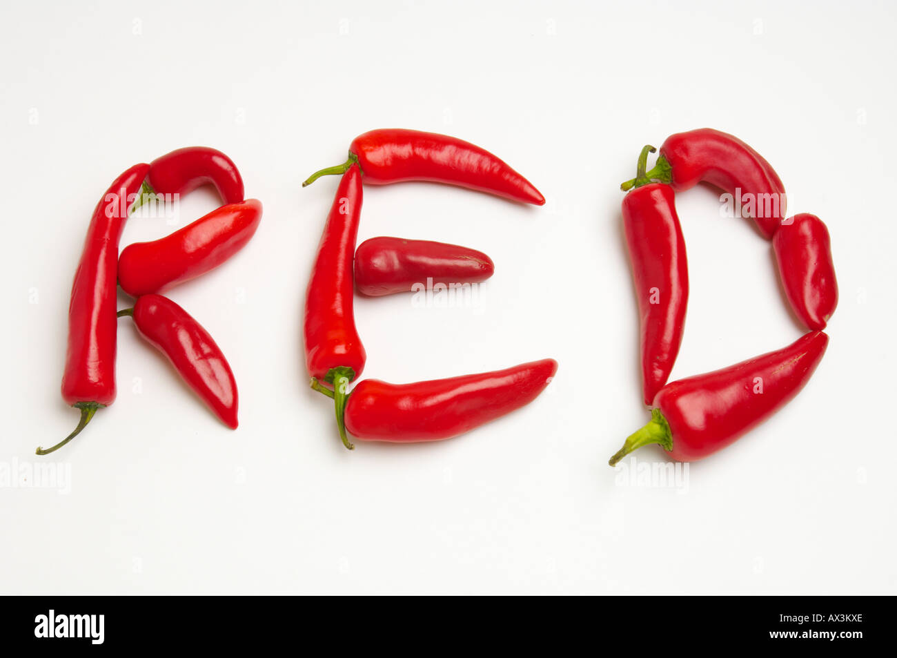 Red chili peppers spell out words relating to their taste Stock Photo