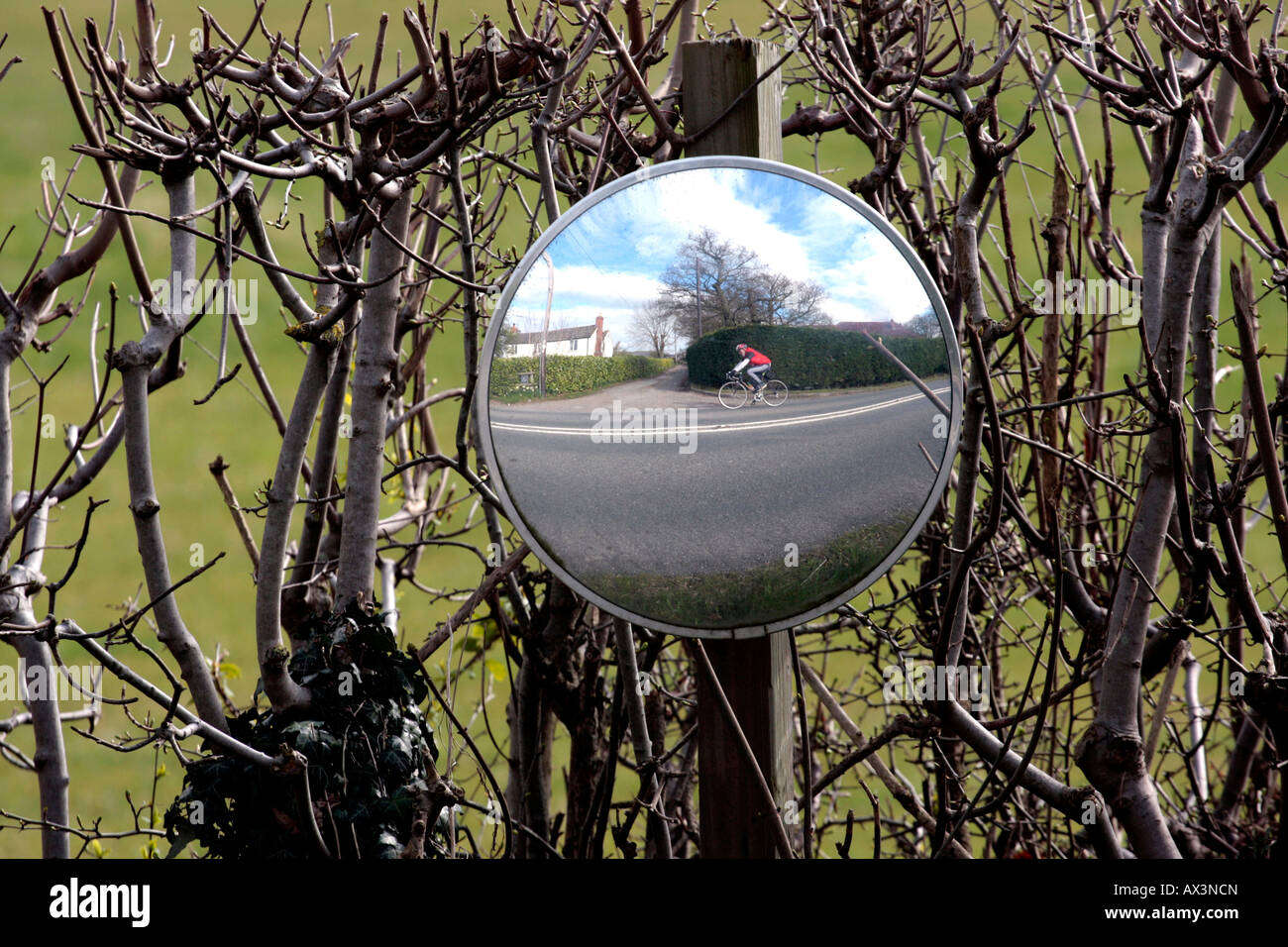 cyclist-reflected-in-a-convex-safety-mirror-on-roadside-stock-photo-alamy