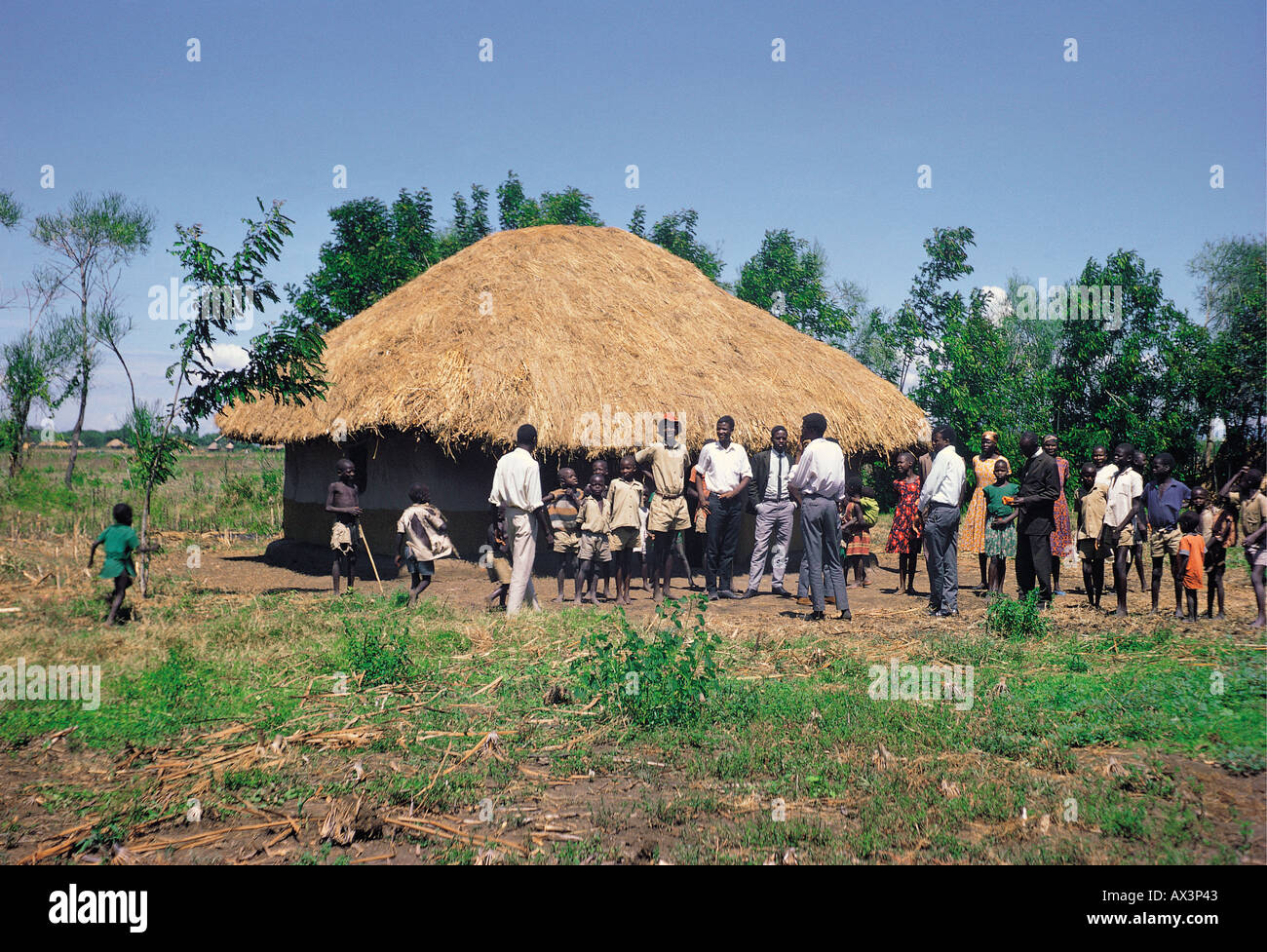 An extended Luo family of adults and children outside their home in South Nyanza western Kenya East Africa Stock Photo