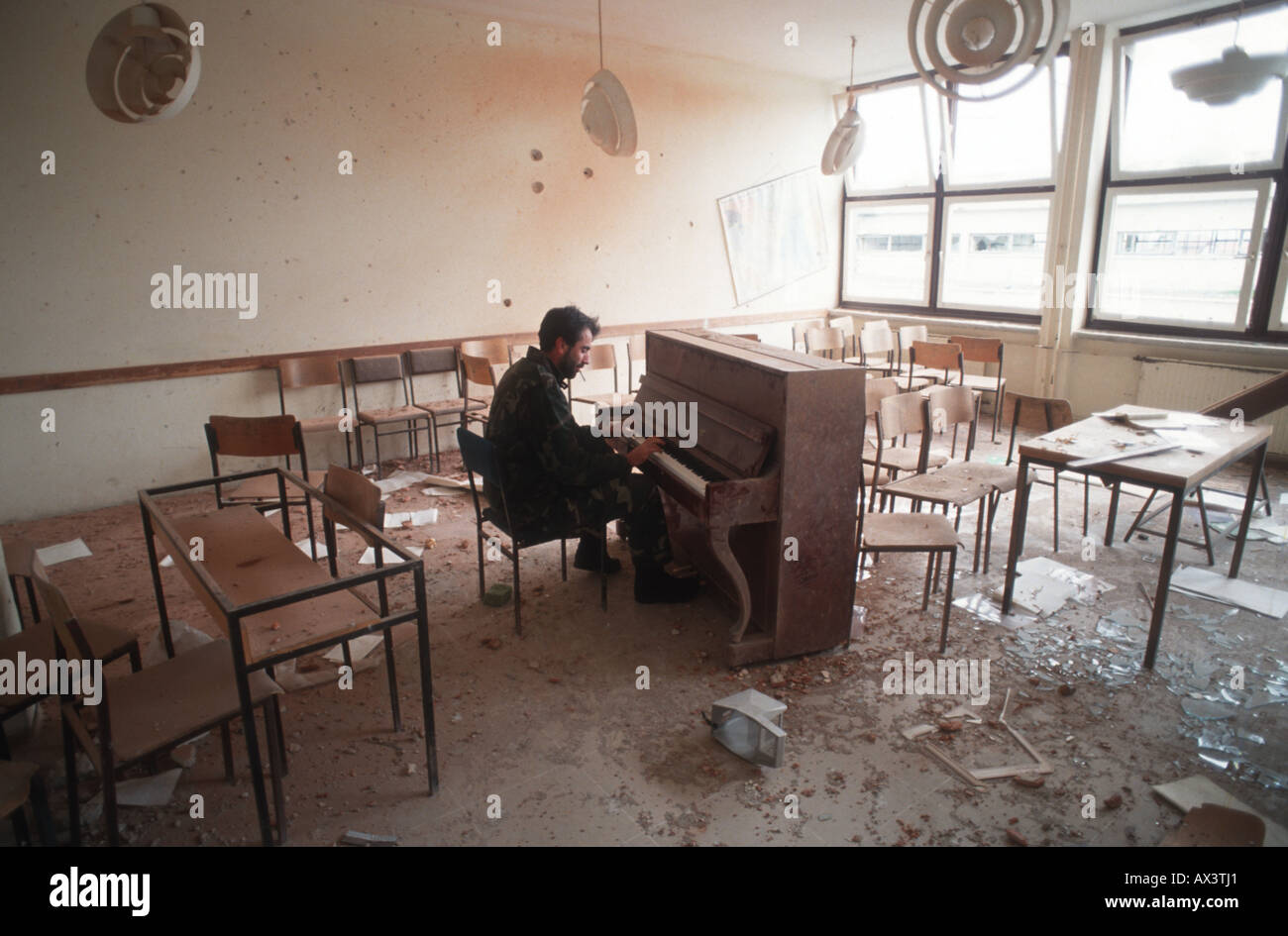 A man in Sarajevo plays a piano in the classroom where he was a teacher  before the civil war Stock Photo - Alamy