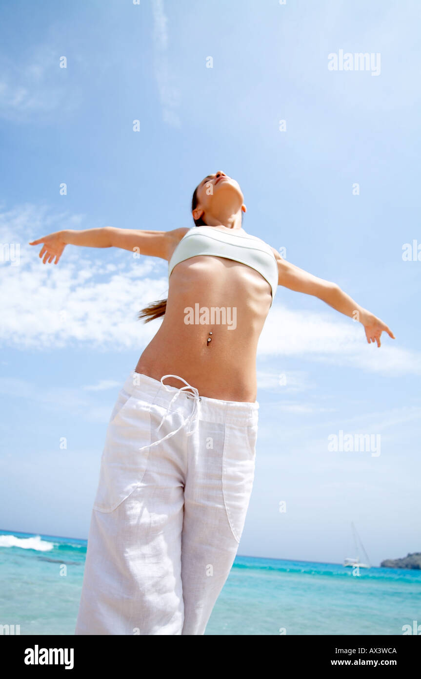 Beach wellness young woman doing a yoga excercise Sun woman beach holiday lifestyle relax summer Stock Photo