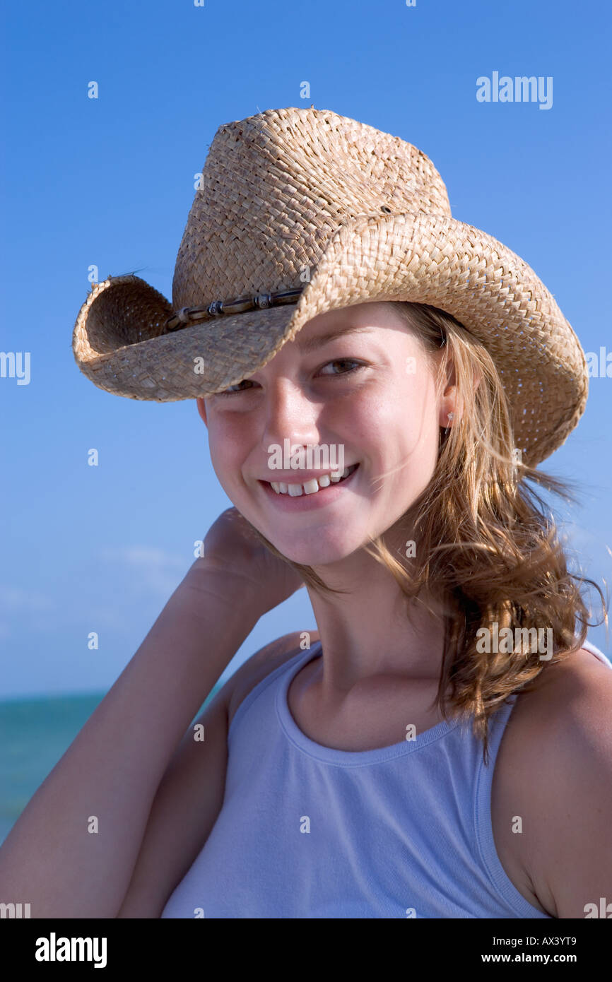 Young caucasian woman wearing straw hat and smiling in Key West