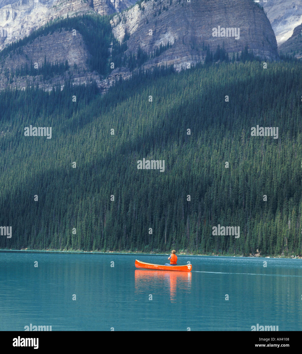 man paddling canoe on Lake Louise in Banff National Park Alberta Canada Stock Photo