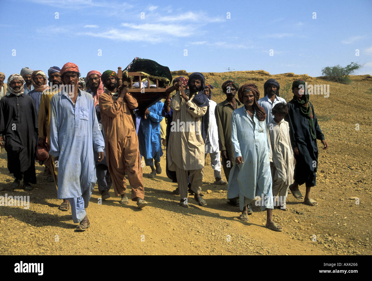 Farmers carrying the funeral bier of a woman in Sindh, Pakistan. She died giving birth. Stock Photo