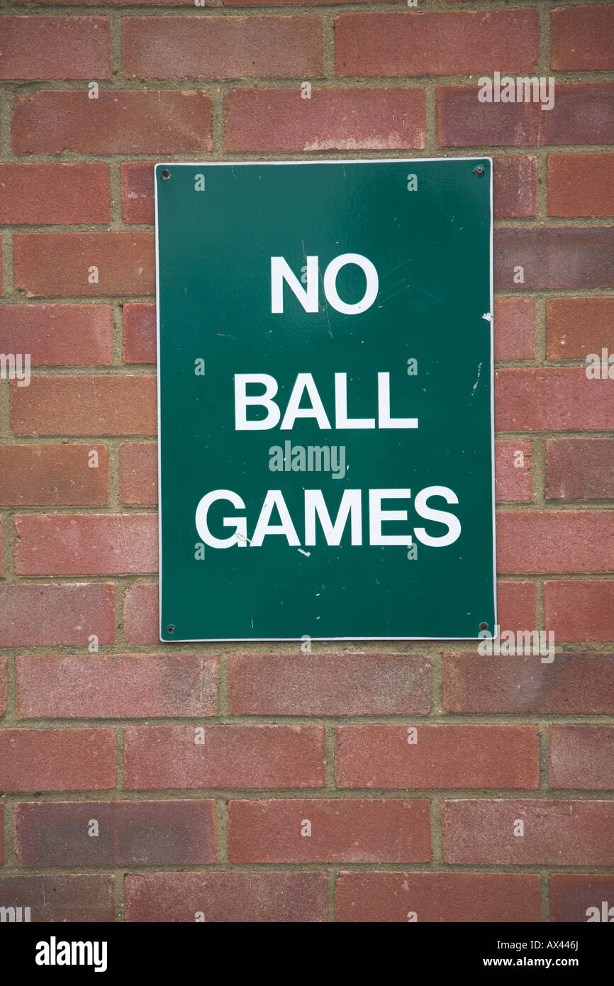 No Ball Games green sign on brick wall Stock Photo