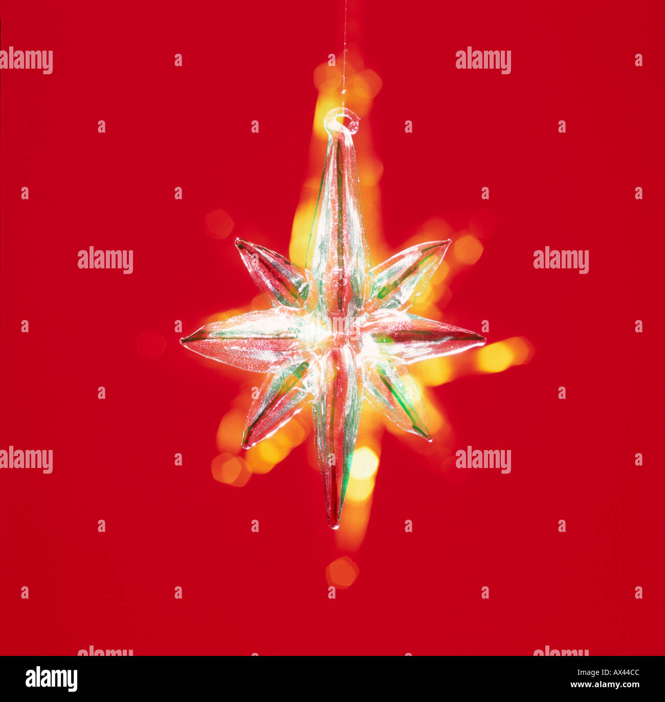 Christmas star bauble on red Stock Photo