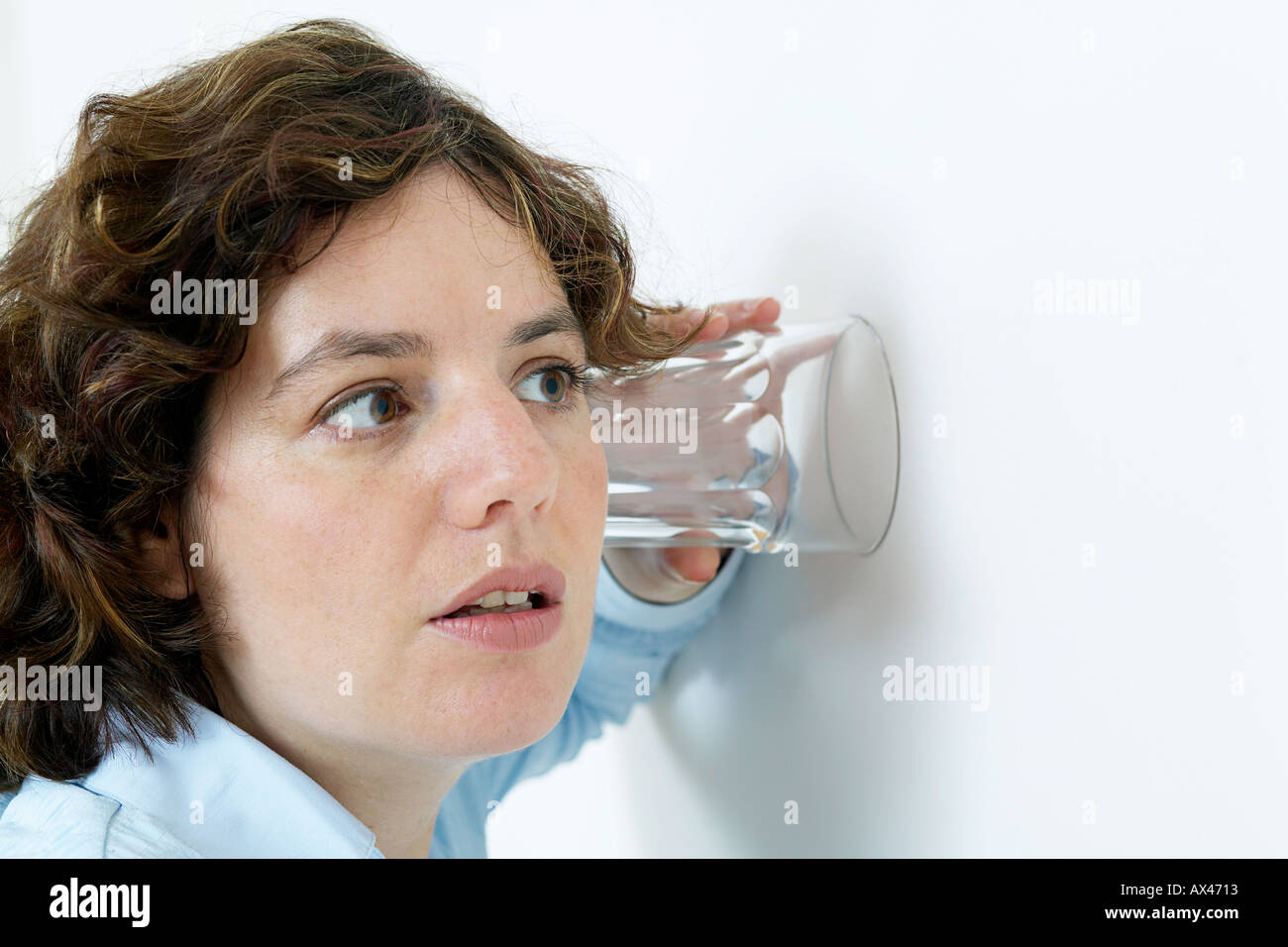 woman listening to conversation through wall with an ear to a glass Stock  Photo - Alamy