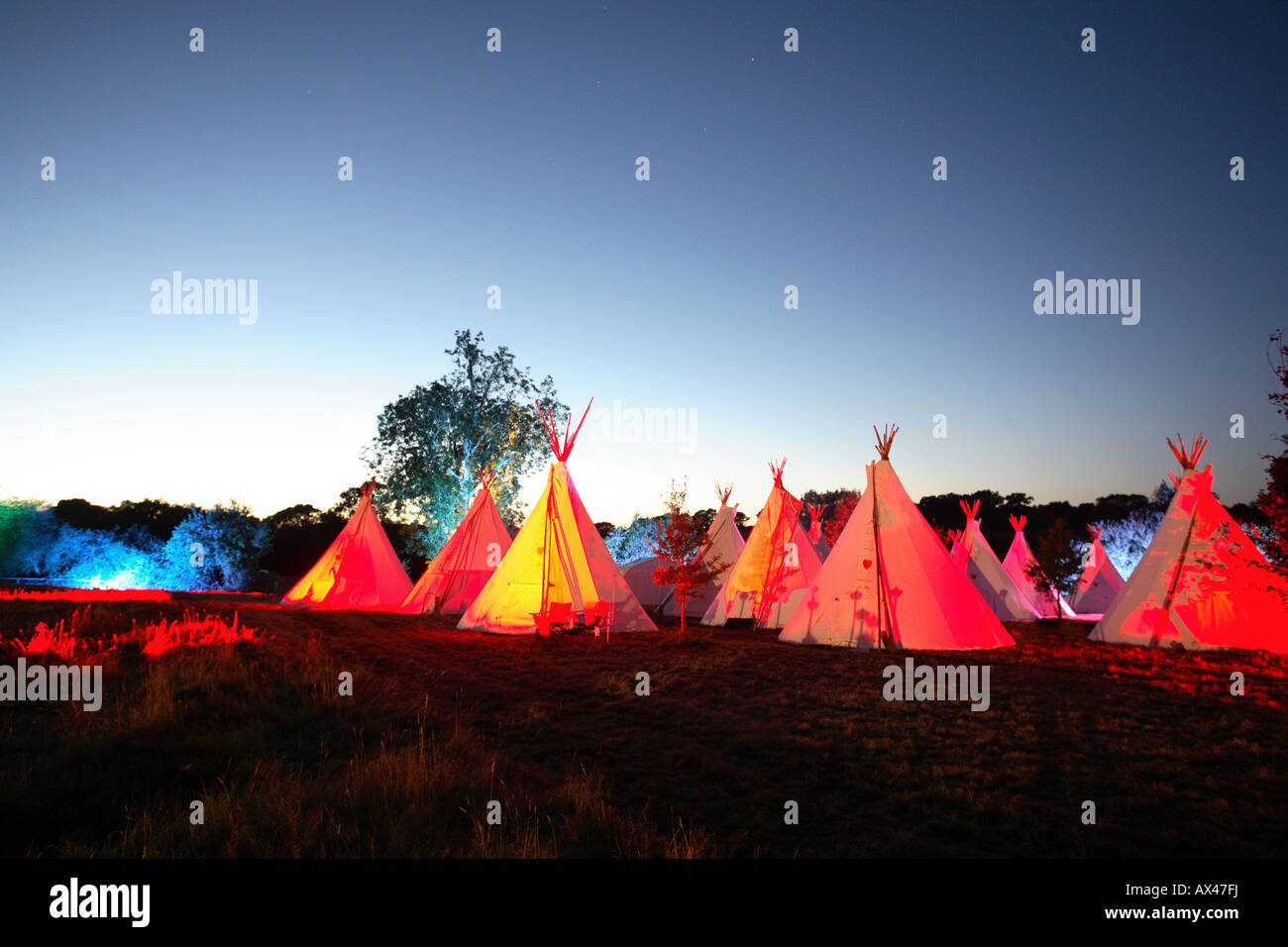 A row of teepees at sunset in an English field Stock Photo