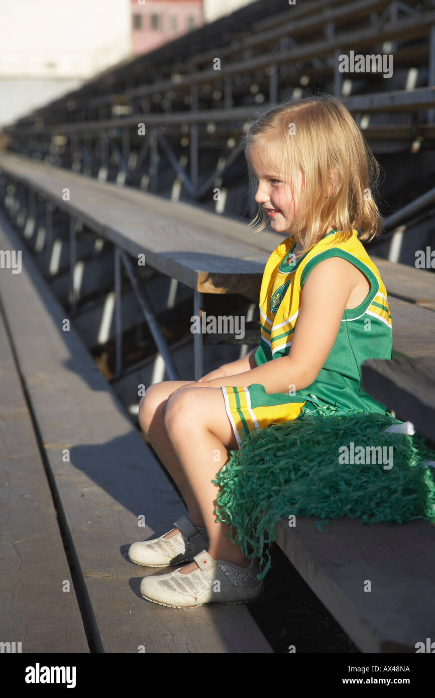 Girl Dressed as Cheerleader in Bleachers Stock Photo Alamy