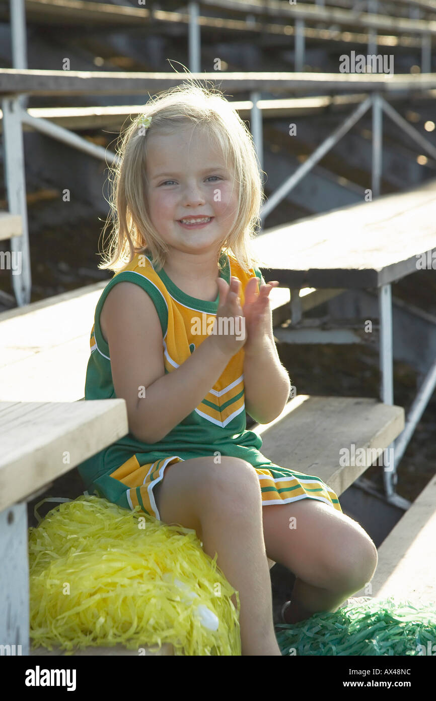 Girl Dressed as Cheerleader in Bleachers Stock Photo Alamy