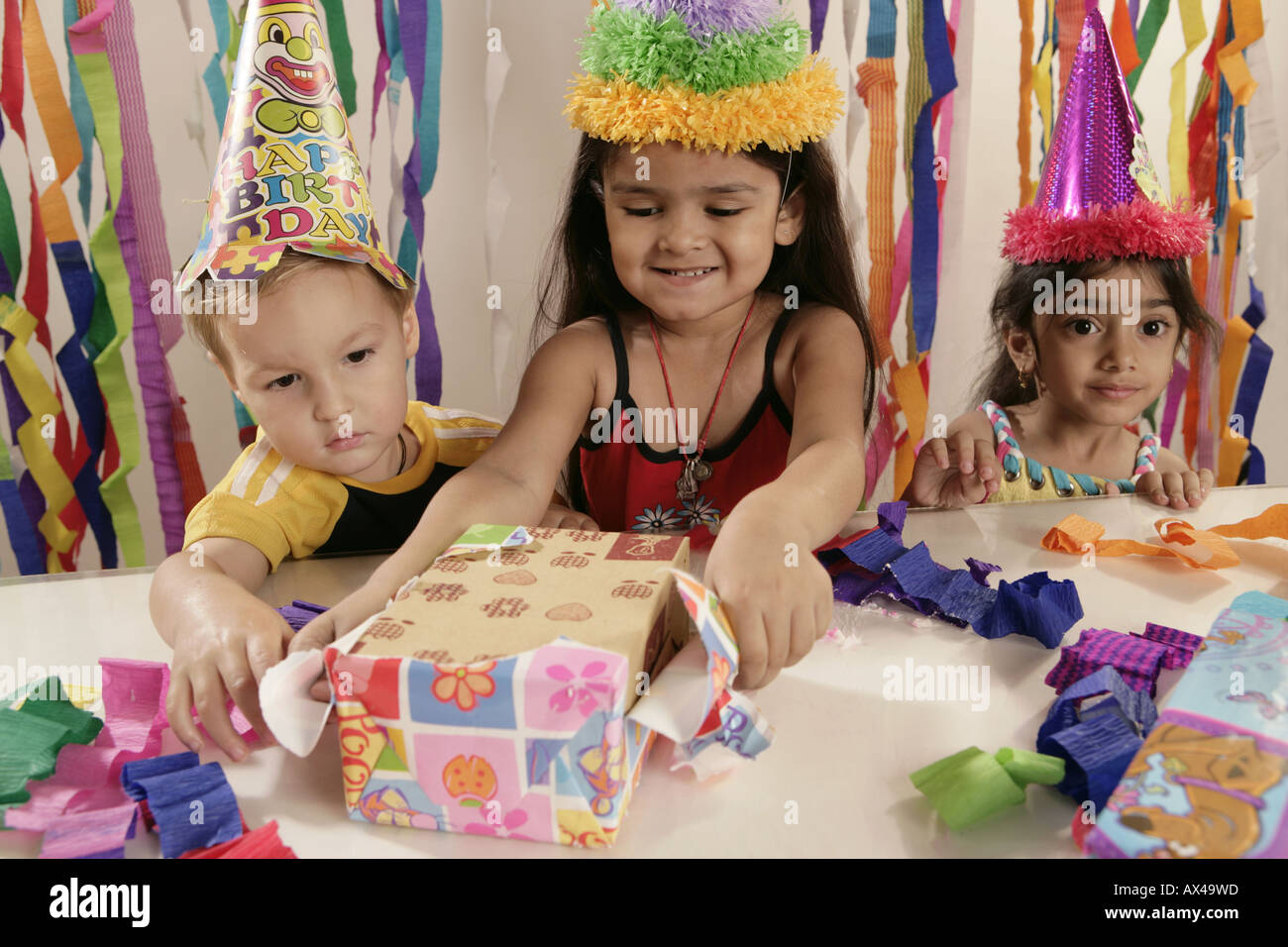 Kids opening gift in a birthday party Stock Photo Alamy