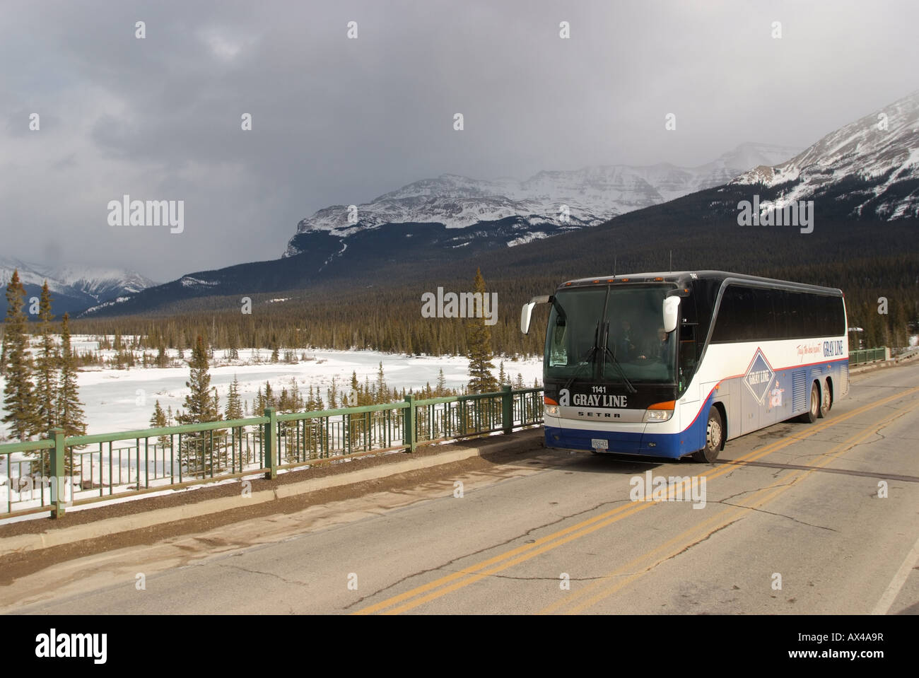 Transportation bus coach passing over the Saskatchewan River in Alberta Canada Stock Photo