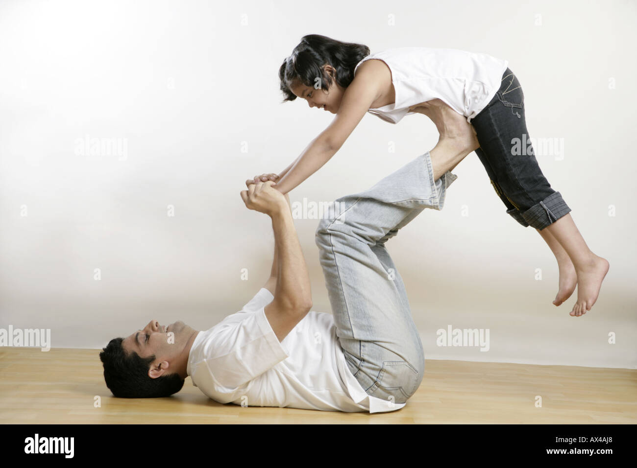 Side profile of a father playing with his daughter Stock Photo