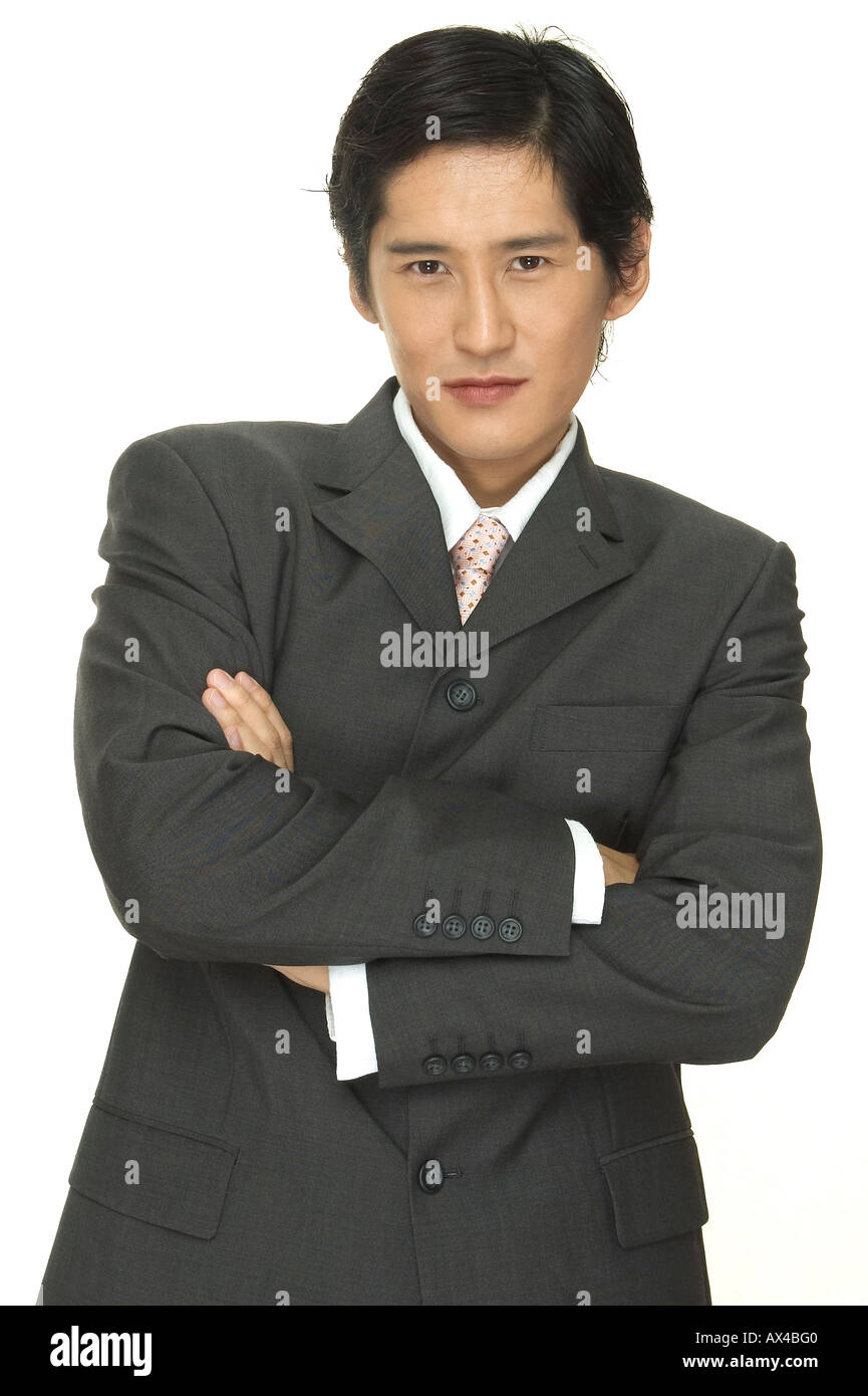 A smart asian businessman with his arms folded across his chest Stock