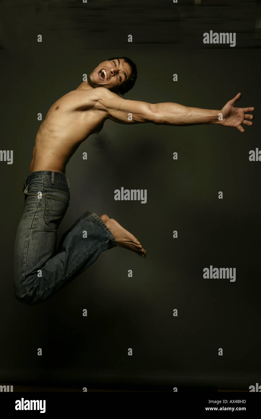 Side profile of a bare chest man jumping Stock Photo Alamy