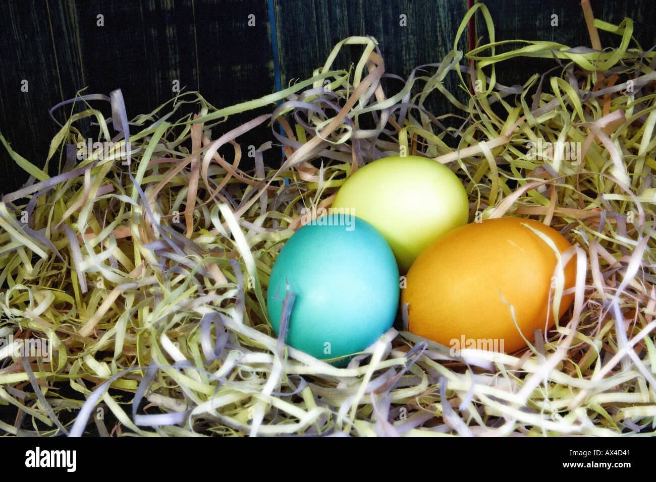 Colored eggs in straw Stock Photo