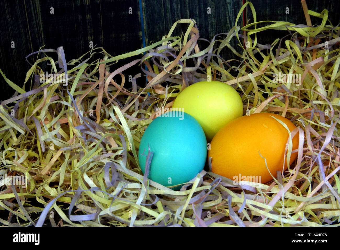 Colored eggs in straw Stock Photo