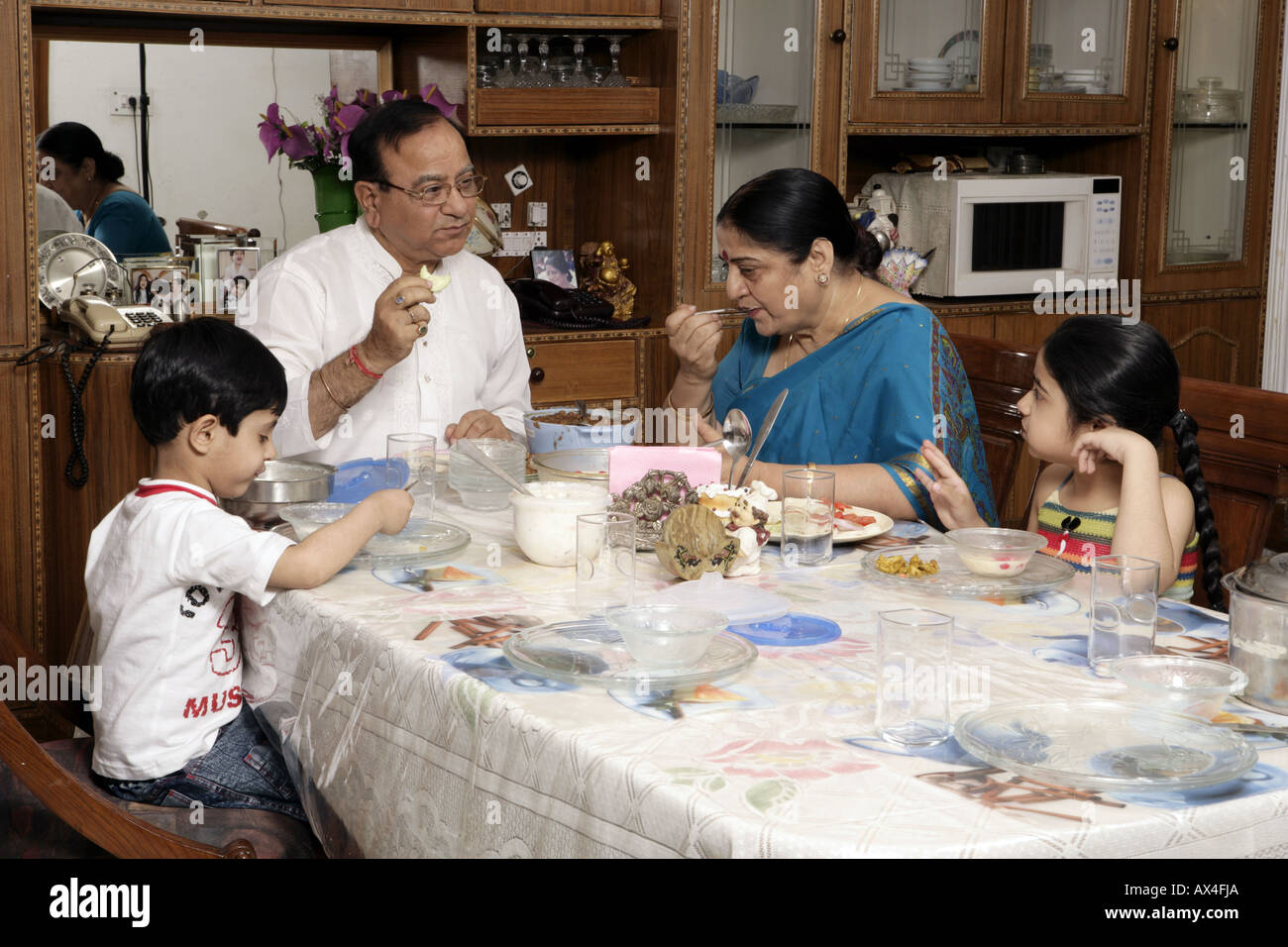 Grandparents eating dinner with their grandchildren Stock Photo - Alamy