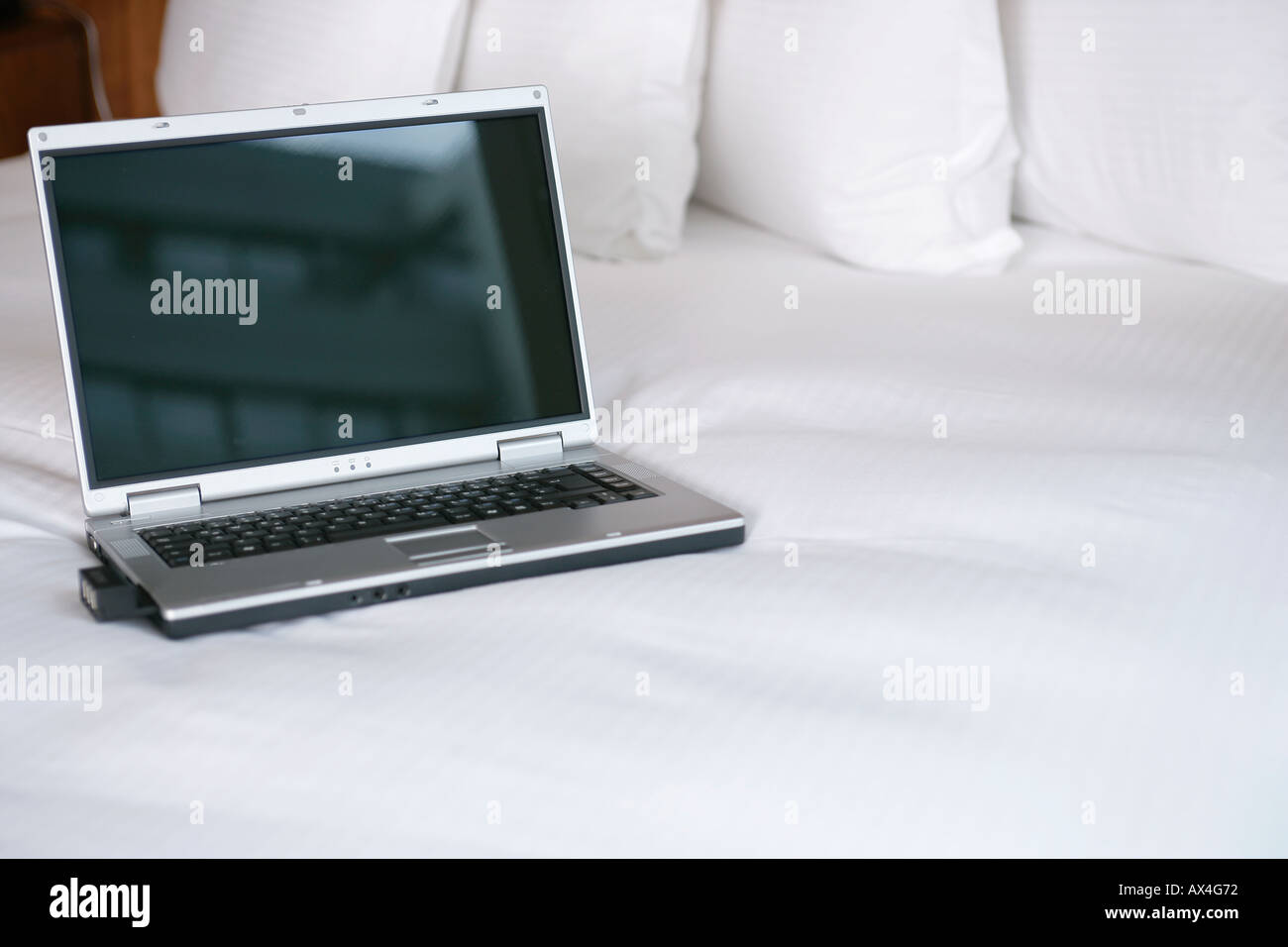 Laptop computer on bed Stock Photo Alamy