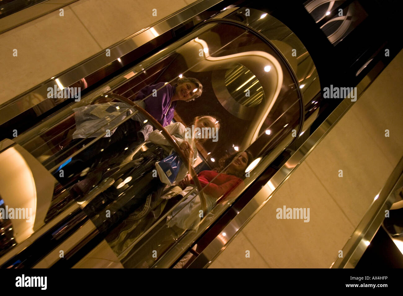 Glass elevator in atrium of color fantasy hires stock photography and