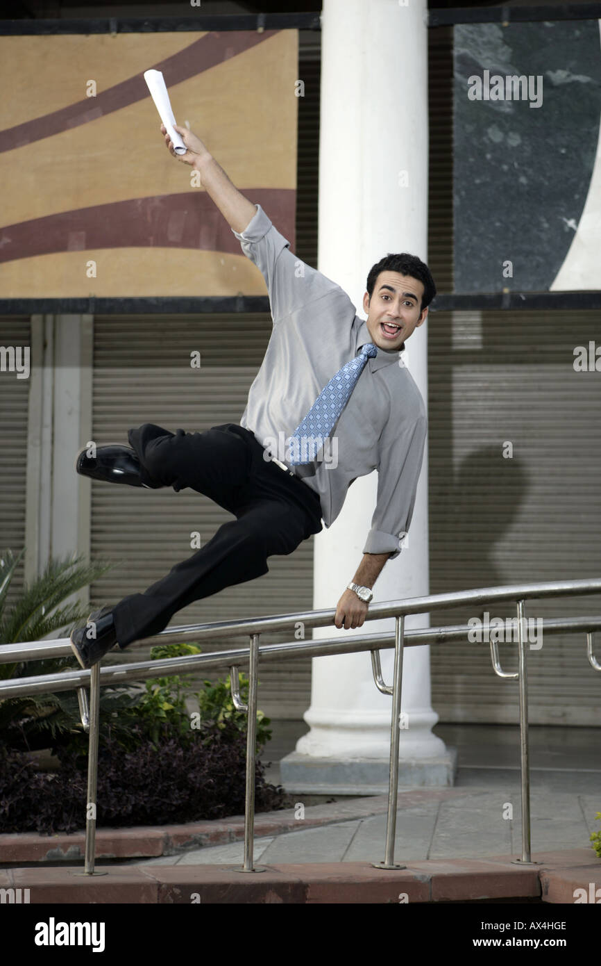 Portrait of a businessman jumping over a railing Stock Photo Alamy