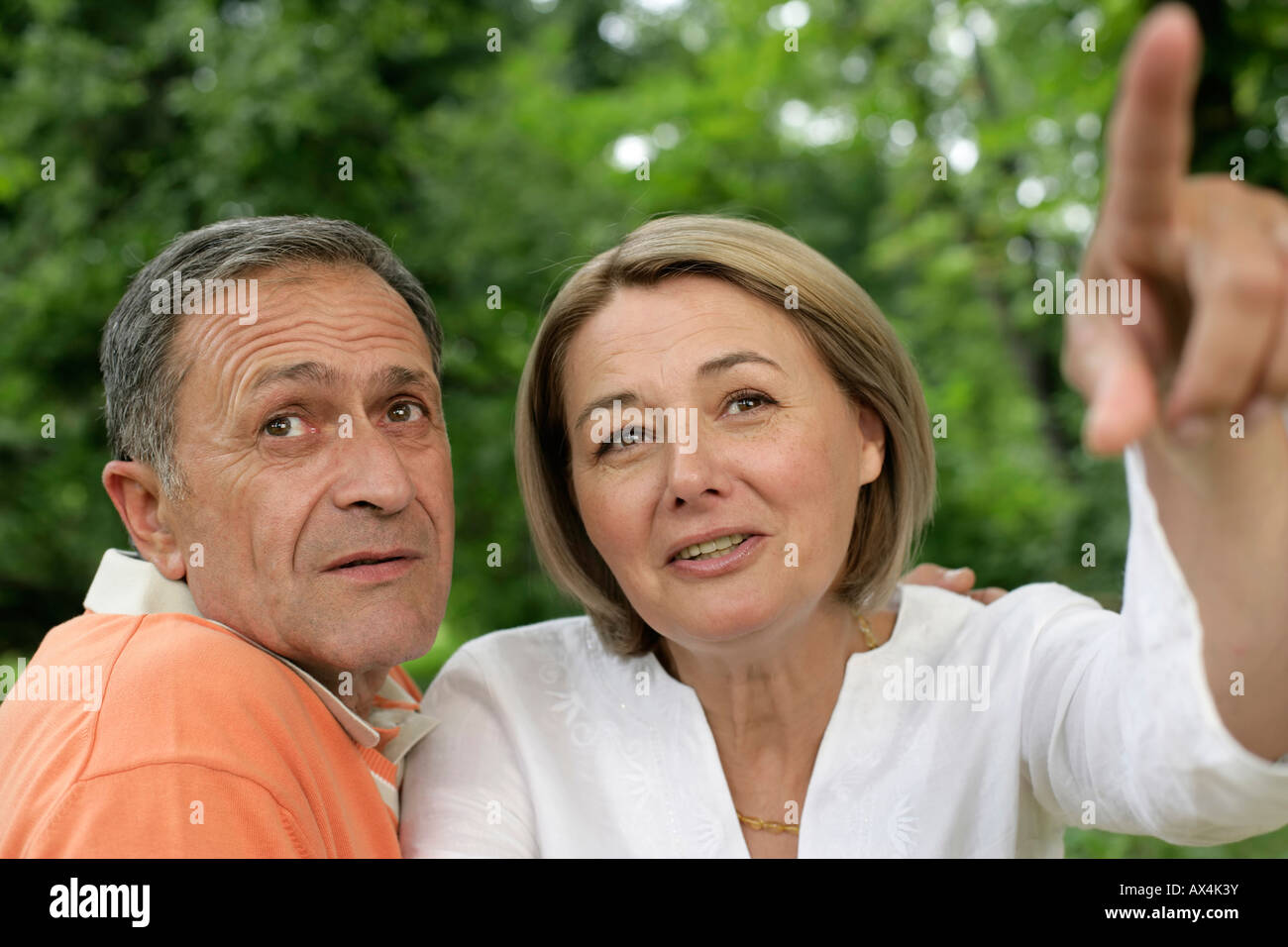 Mature woman showing man something Stock Photo