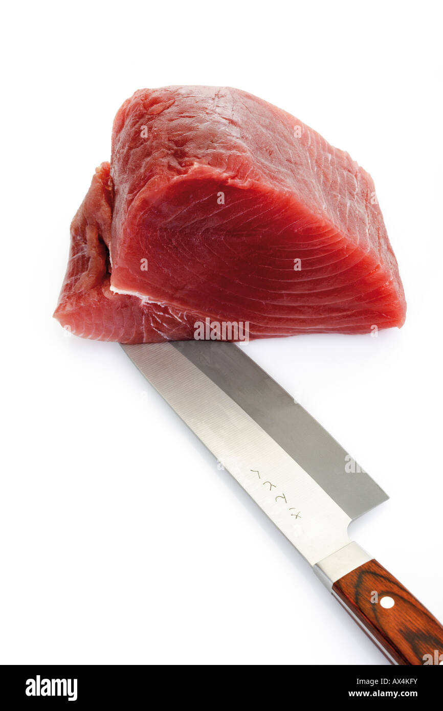 Sliced raw tuna with knife Stock Photo Alamy
