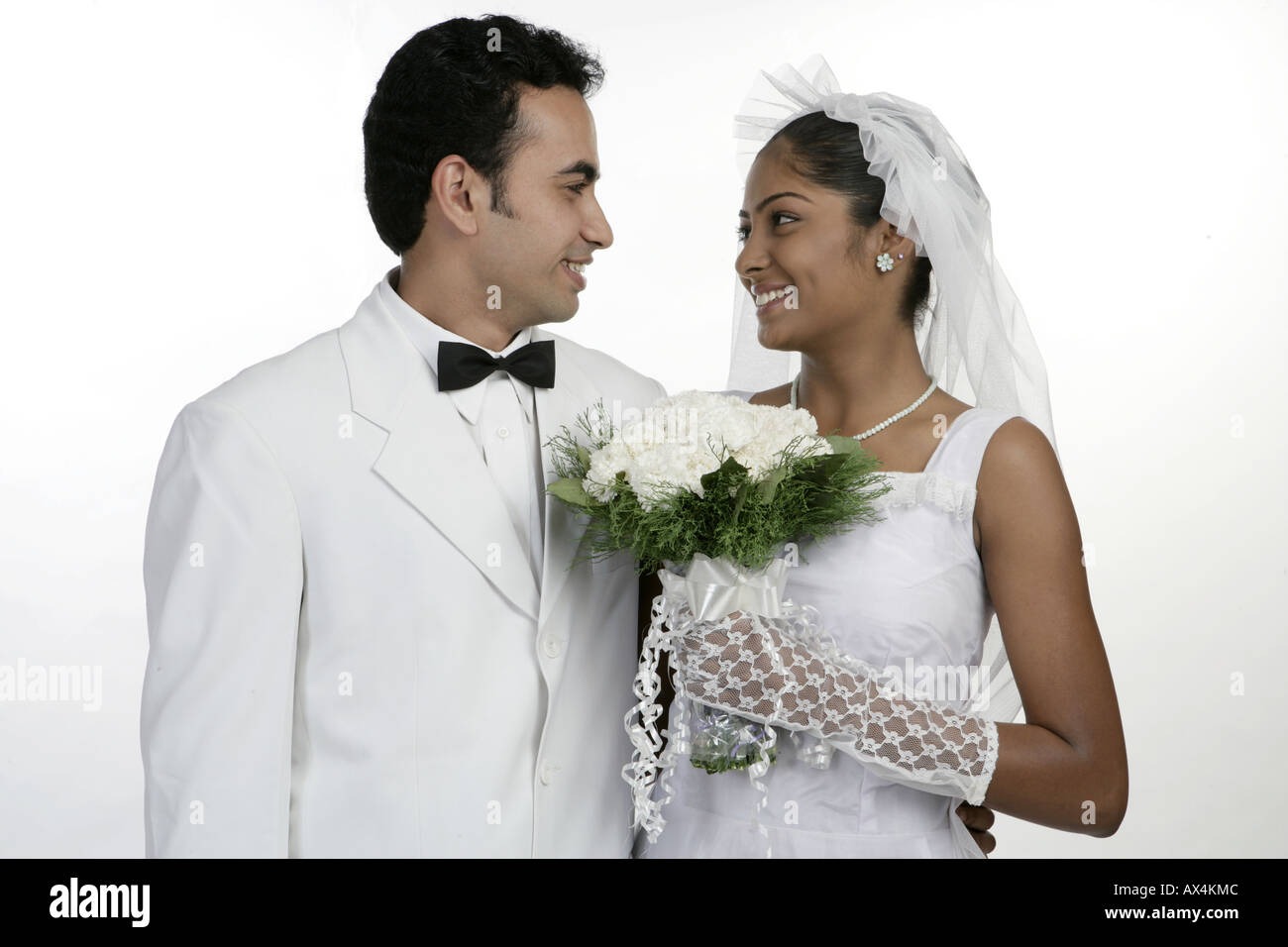 Bride and groom looking at each other and smiling Stock Photo