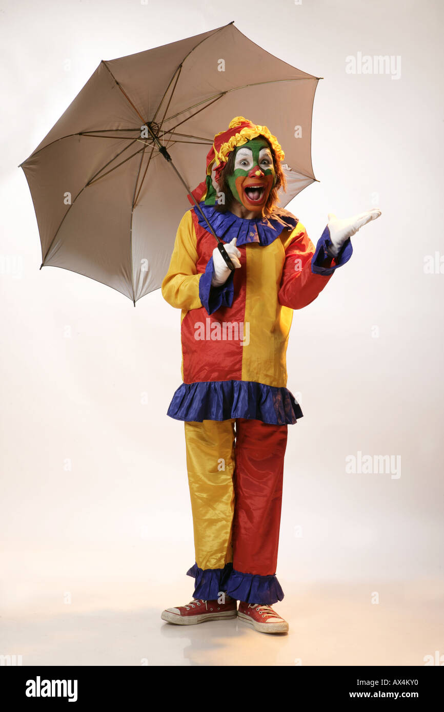 Portrait of a joker holding an umbrella and gesturing Stock Photo - Alamy