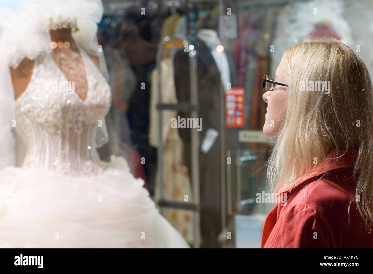 A fiance dreams about her wedding day while gazing at a wedding dress